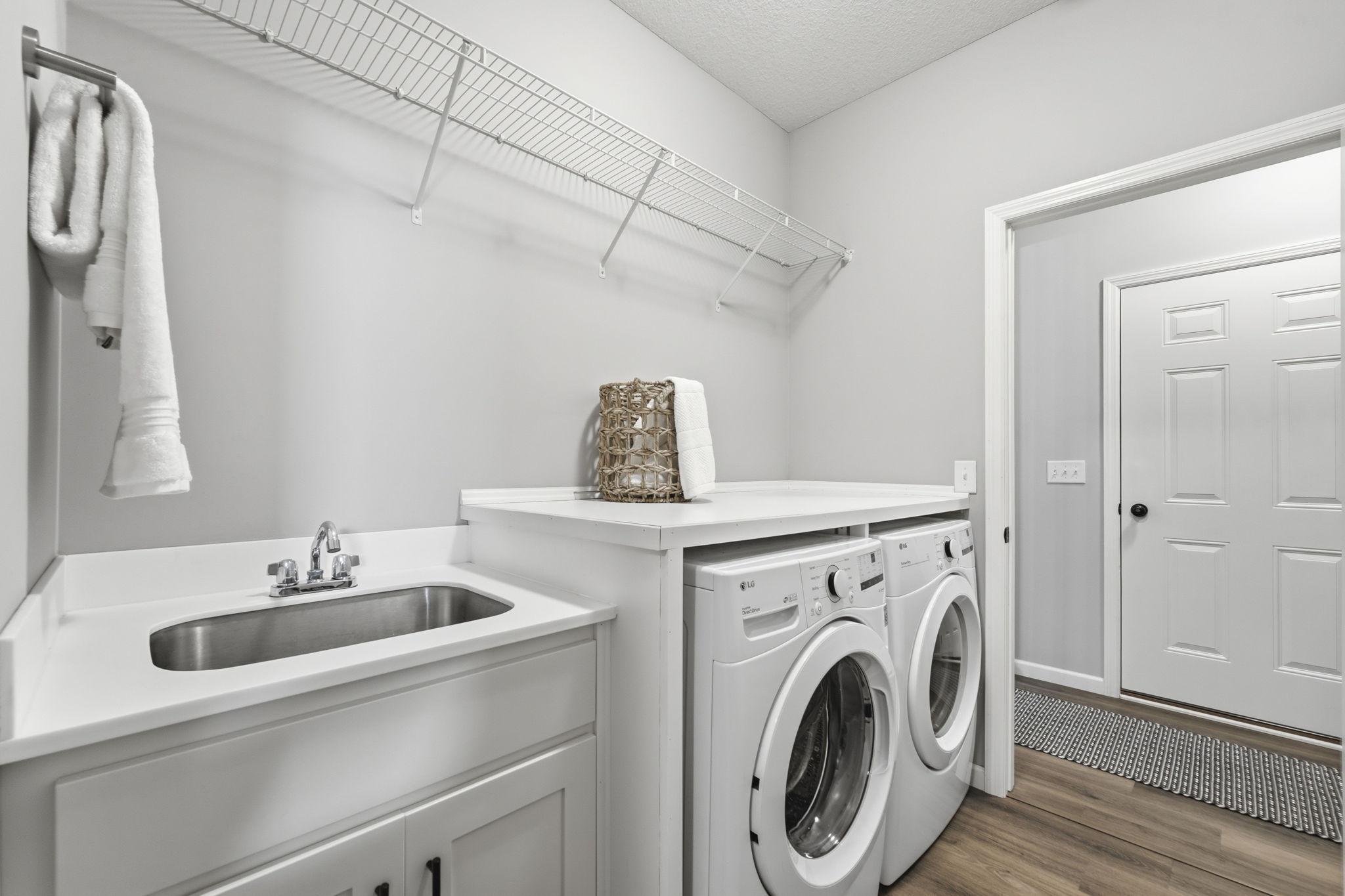 Laundry accessible to both primary closet and hall