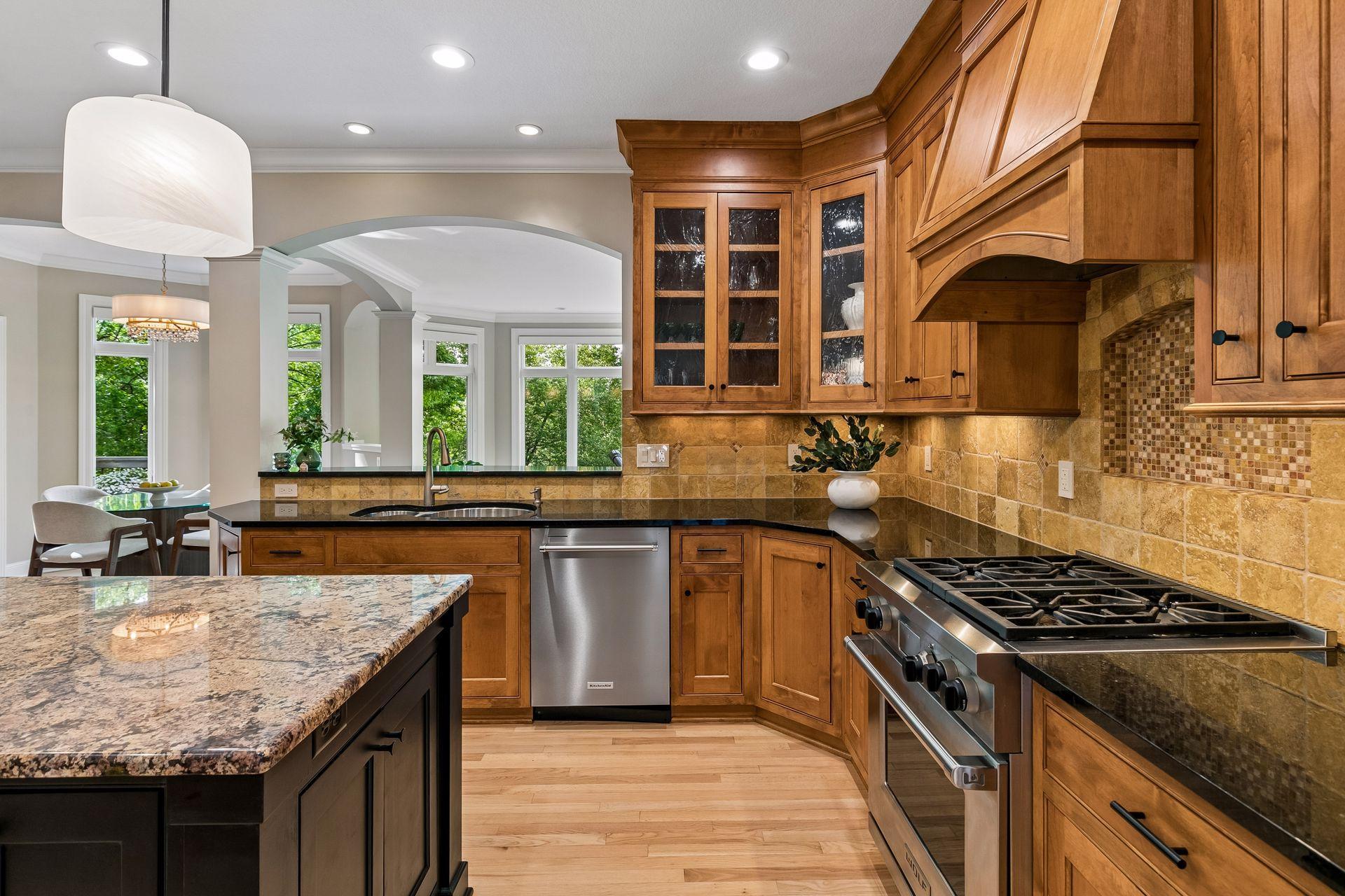 The heart of the home, this spotless kitchen features Wolf appliances, newly refinished granite countertops, beautifully refinished hardwood floors, and cabinets galore.