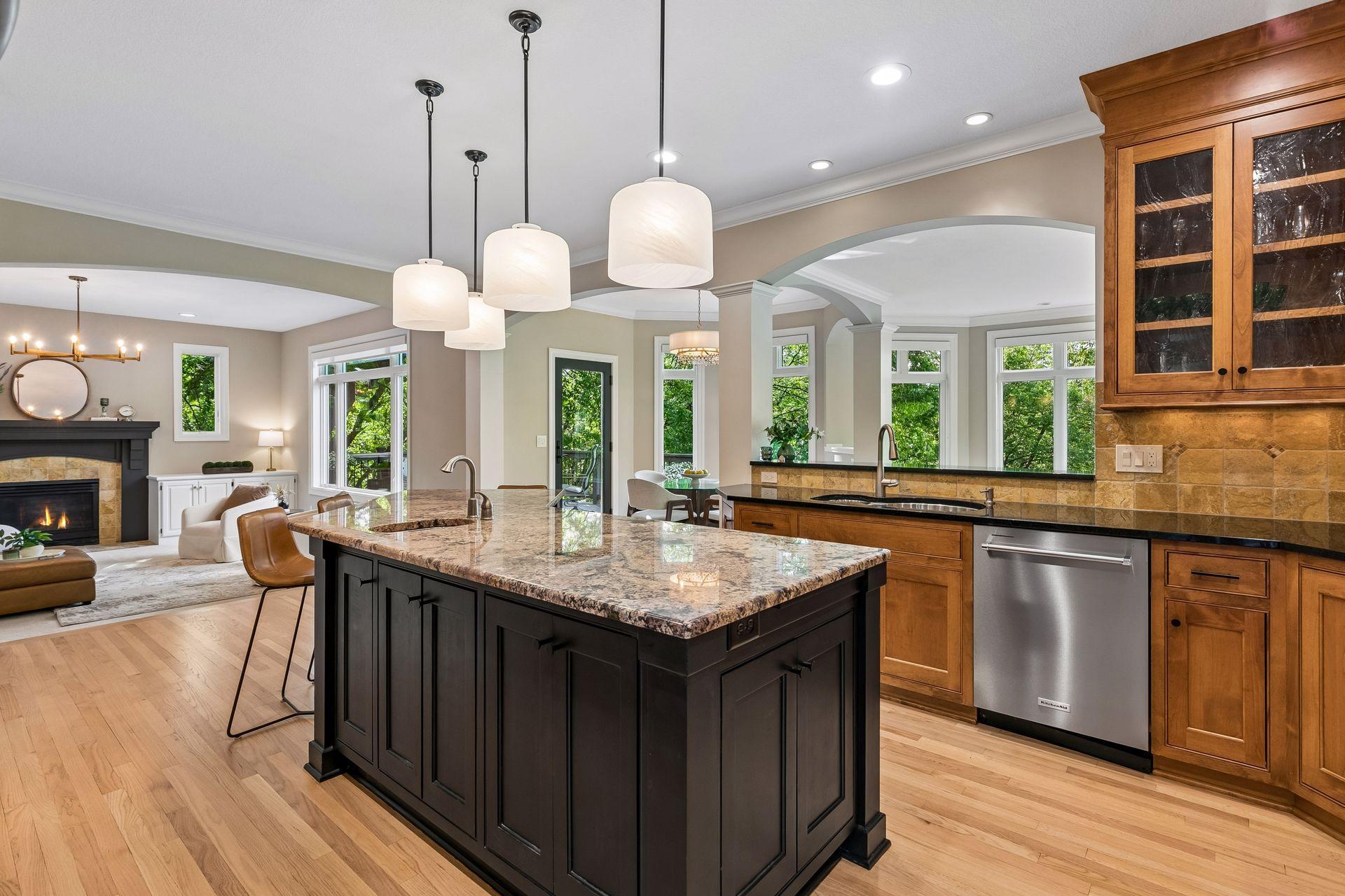 The heart of the home, this spotless kitchen features Wolf appliances, newly refinished granite countertops, beautifully refinished hardwood floors, and cabinets galore.