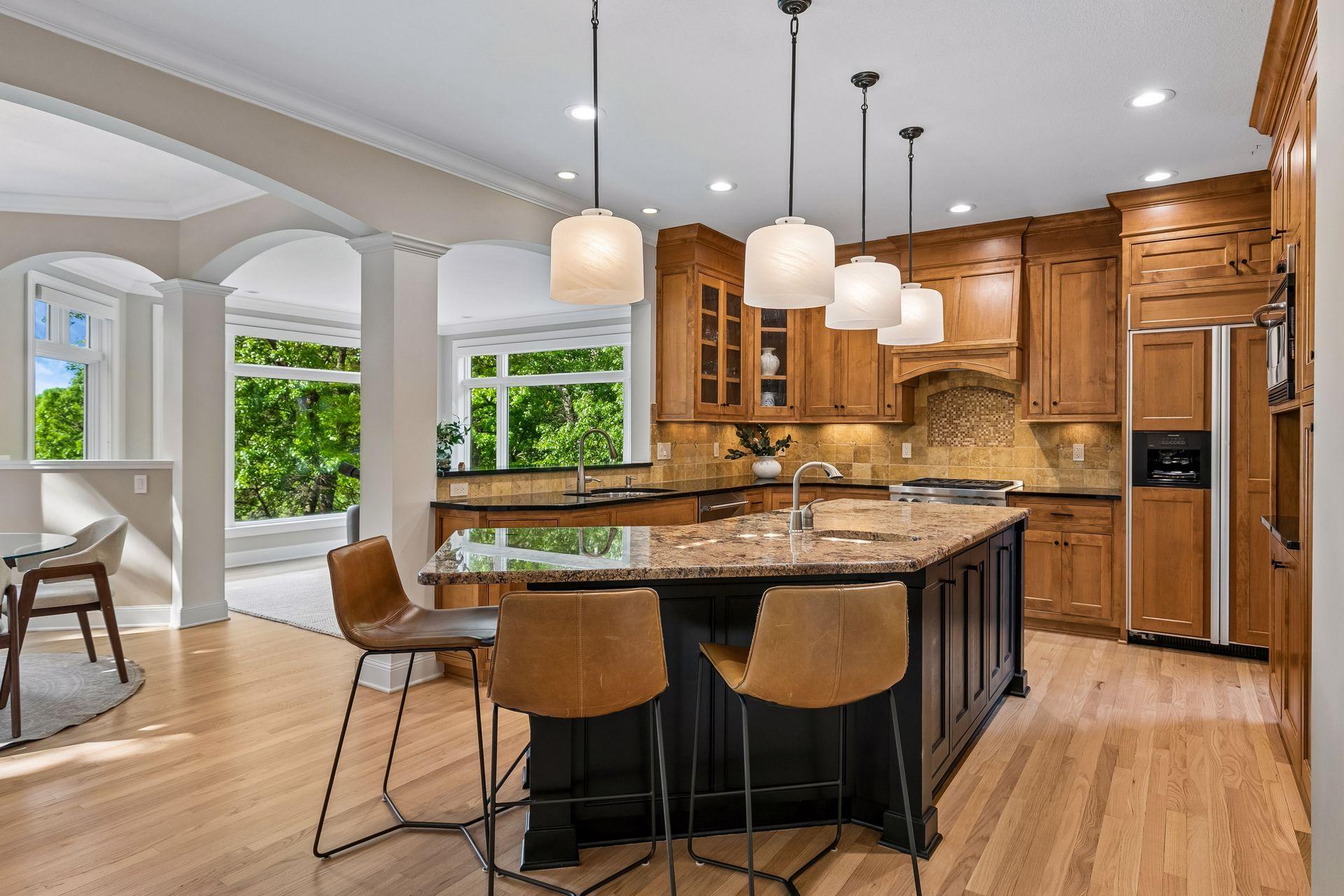 The heart of the home, this spotless kitchen features Wolf appliances, newly refinished granite countertops, beautifully refinished hardwood floors, and cabinets galore.
