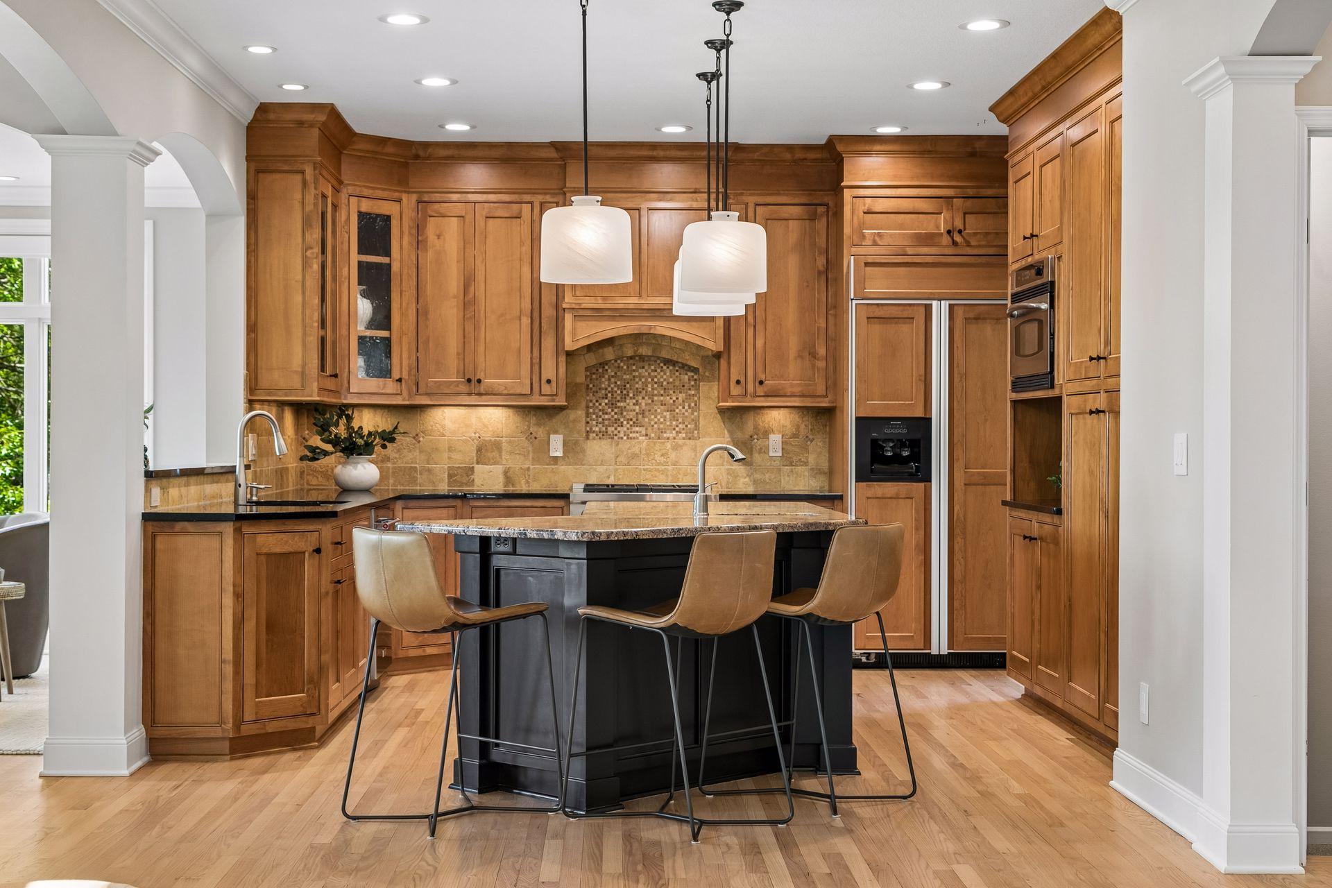 The heart of the home, this spotless kitchen features Wolf appliances, newly refinished granite countertops, beautifully refinished hardwood floors, and cabinets galore.