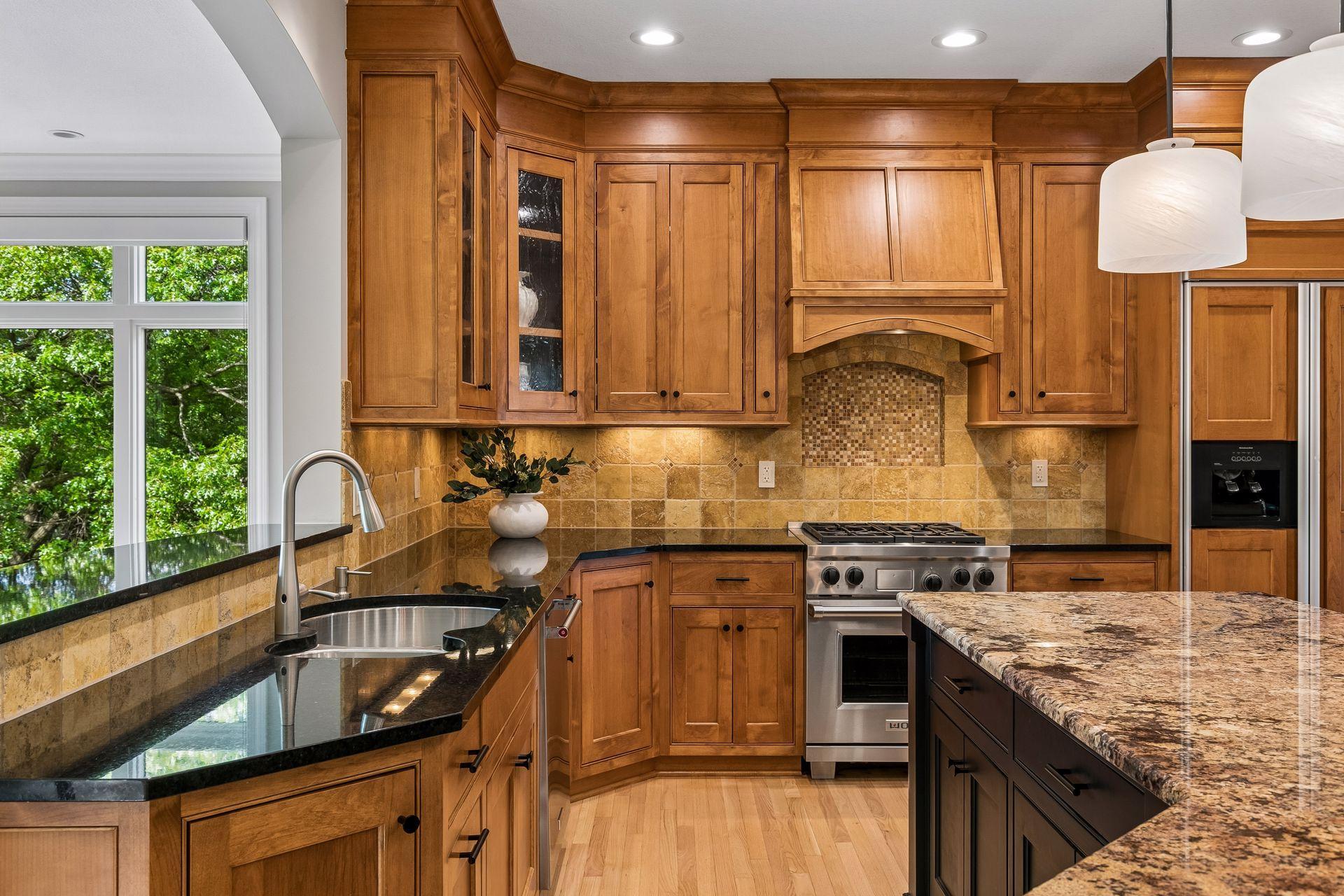 The heart of the home, this spotless kitchen features Wolf appliances, newly refinished granite countertops, beautifully refinished hardwood floors, and cabinets galore.