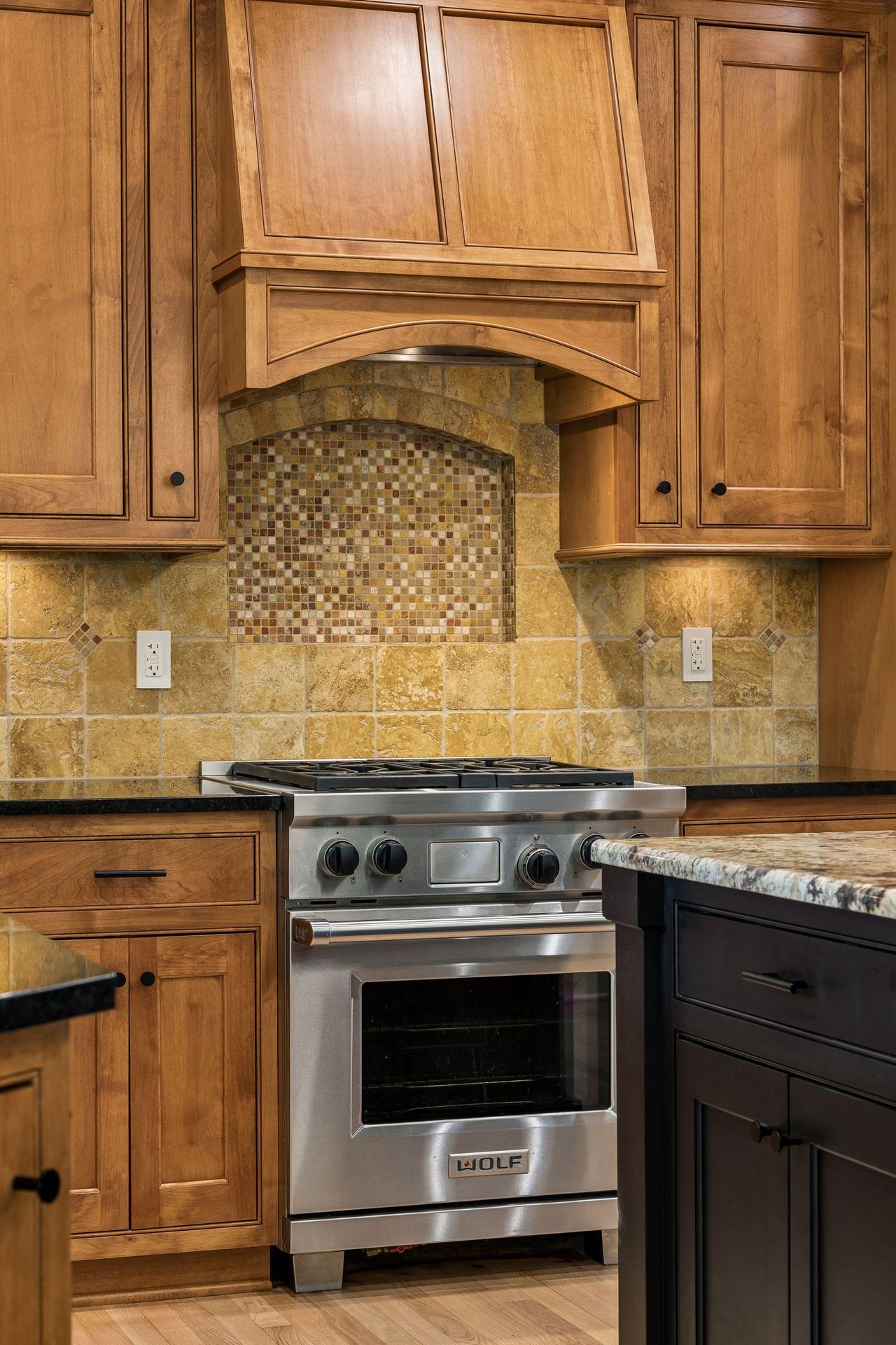 A stunning stone niche above the Wolf range adds warmth, texture, and timeless appeal.