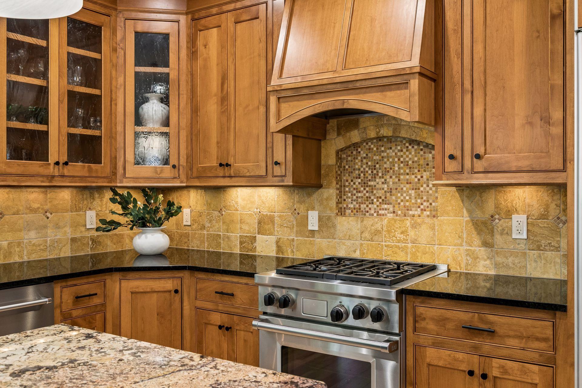 The heart of the home, this spotless kitchen features Wolf appliances, newly refinished granite countertops, beautifully refinished hardwood floors, and cabinets galore.