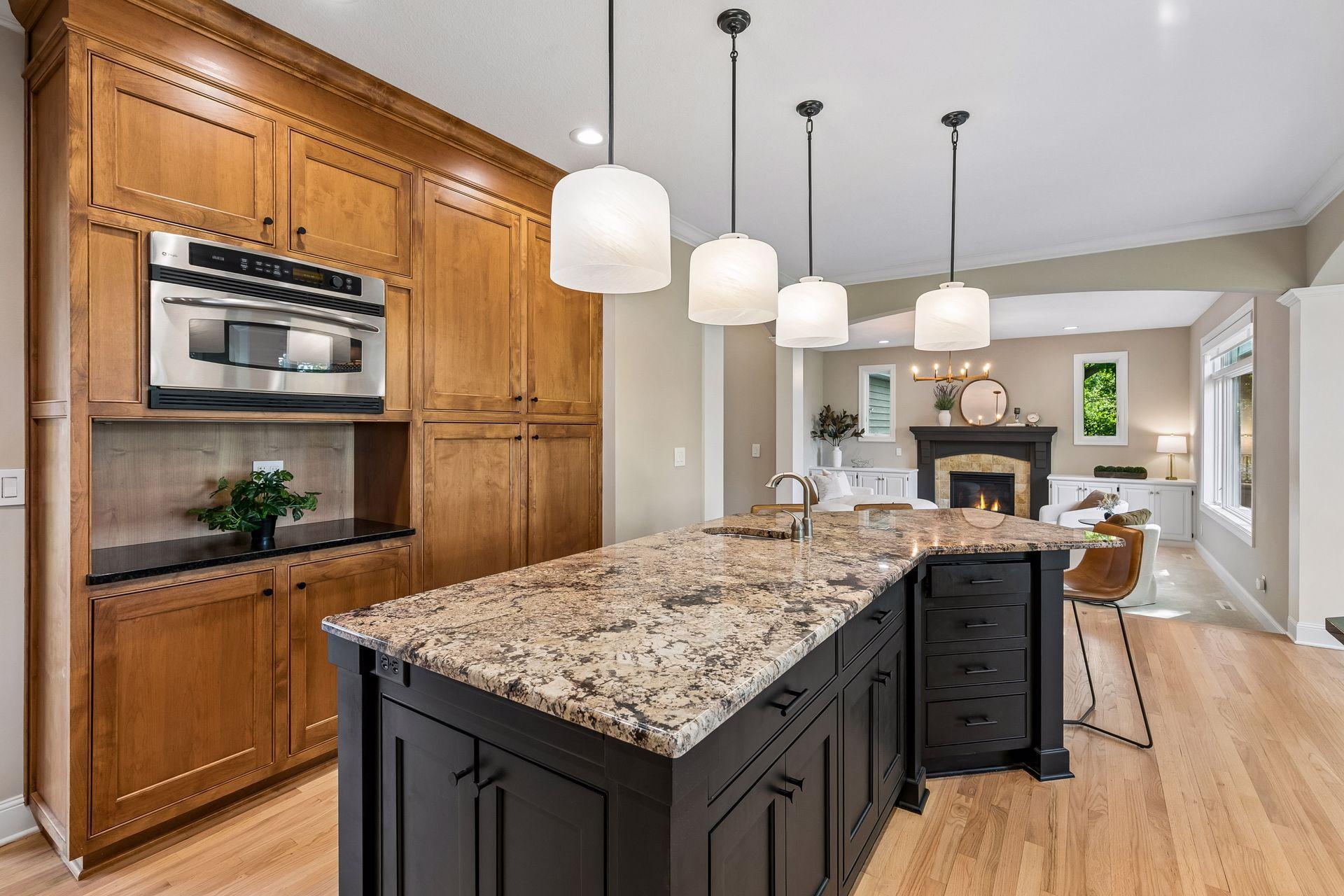 The heart of the home, this spotless kitchen features Wolf appliances, newly refinished granite countertops, beautifully refinished hardwood floors, and cabinets galore.