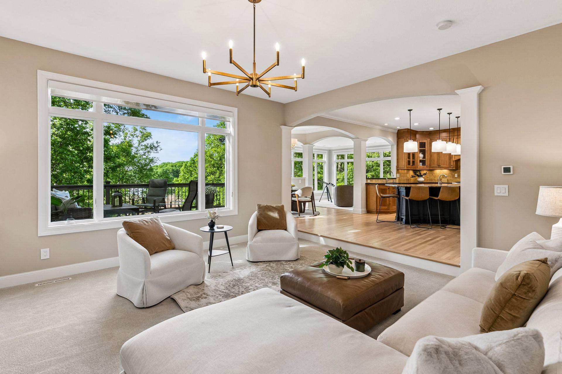 Modern, inviting, and warm, the living room features a cozy gas fireplace, overlooks the deck, and captures beautiful lake views.