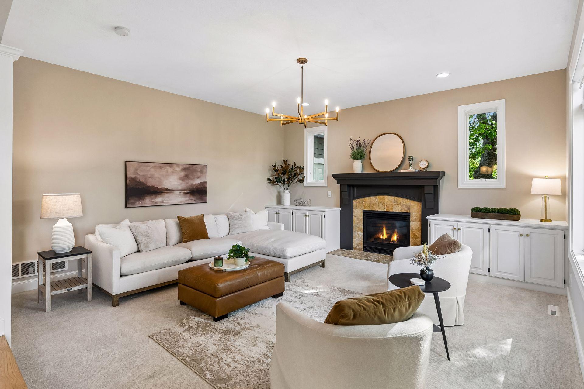 Modern, inviting, and warm, the living room features a cozy gas fireplace, overlooks the deck, and captures beautiful lake views.