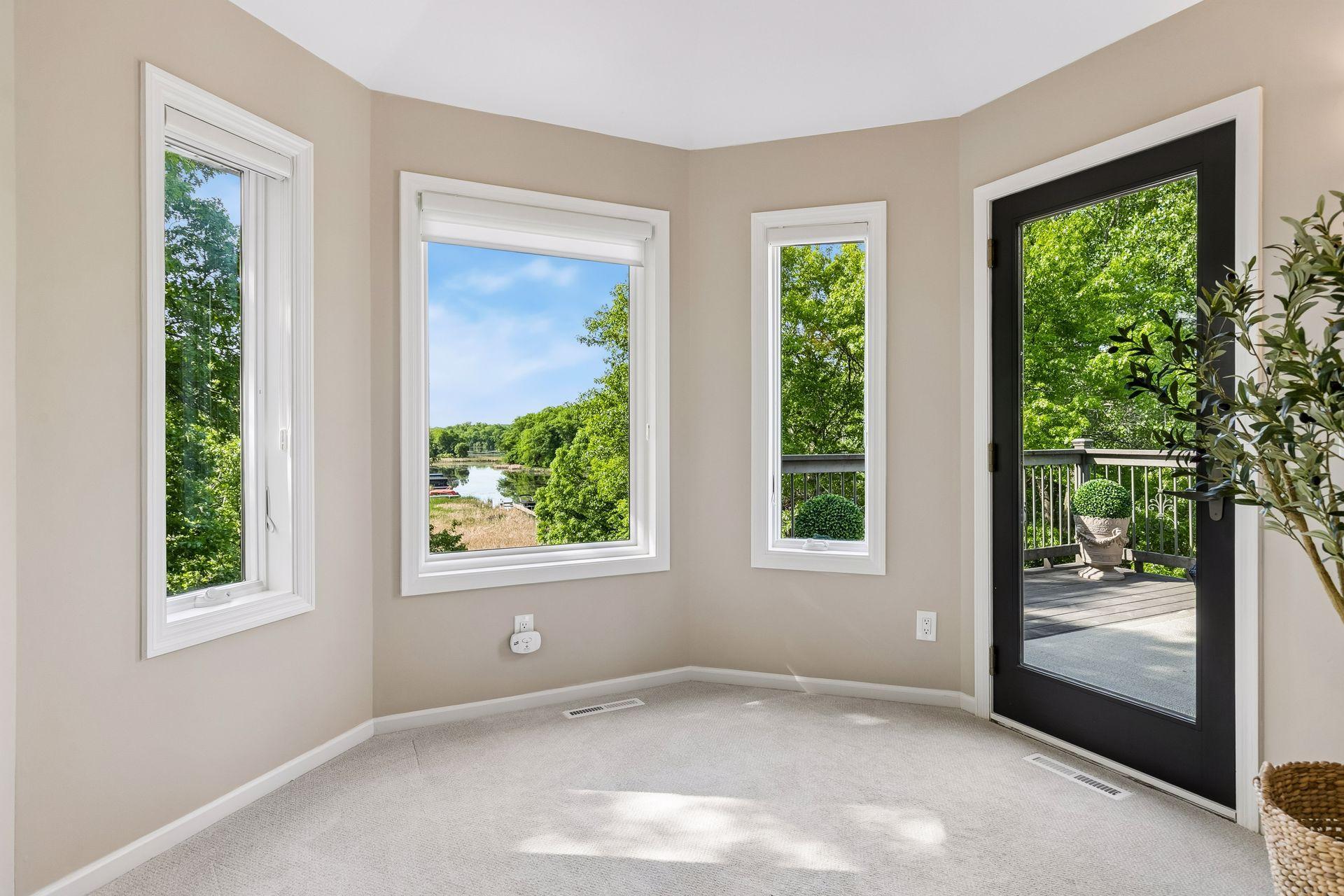 This primary suite is exceptional, featuring a spacious bedroom, a cozy reading nook, and a warm, spa-like bath with a separate tub and shower. Step out onto the private maintenance-free balcony and take in sweeping views of the 1+ acre lot and Lake