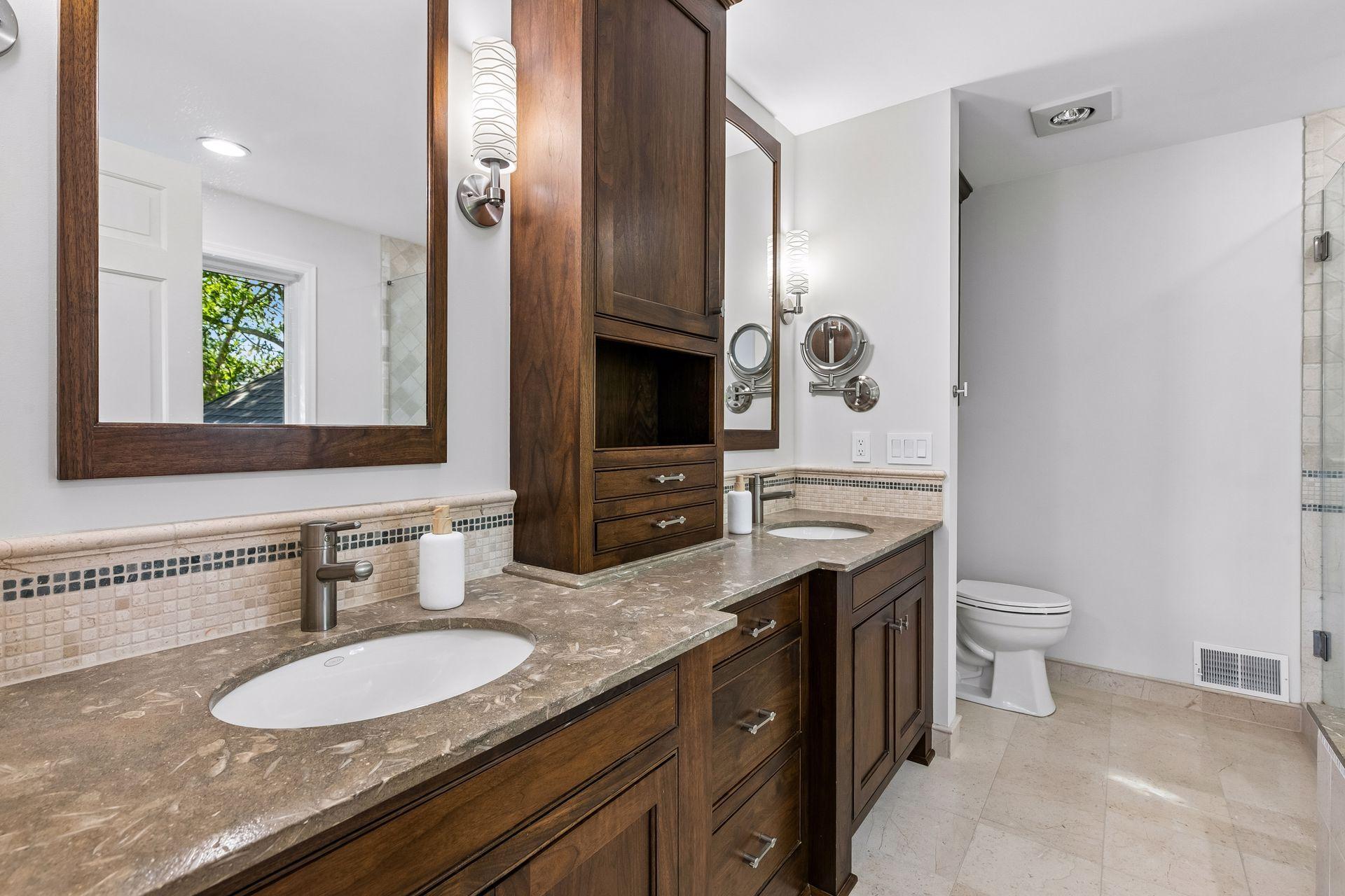 This primary suite is exceptional, featuring a spacious bedroom, a cozy reading nook, and a warm, spa-like bath with a separate tub and shower. Step out onto the private maintenance-free balcony and take in sweeping views of the 1+ acre lot and Lake