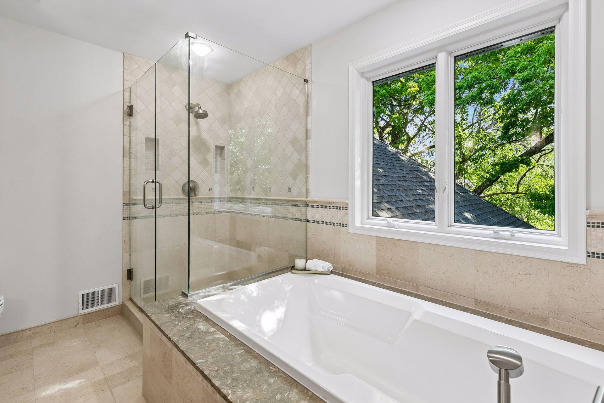This primary suite is exceptional, featuring a spacious bedroom, a cozy reading nook, and a warm, spa-like bath with a separate tub and shower. Step out onto the private maintenance-free balcony and take in sweeping views of the 1+ acre lot and Lake