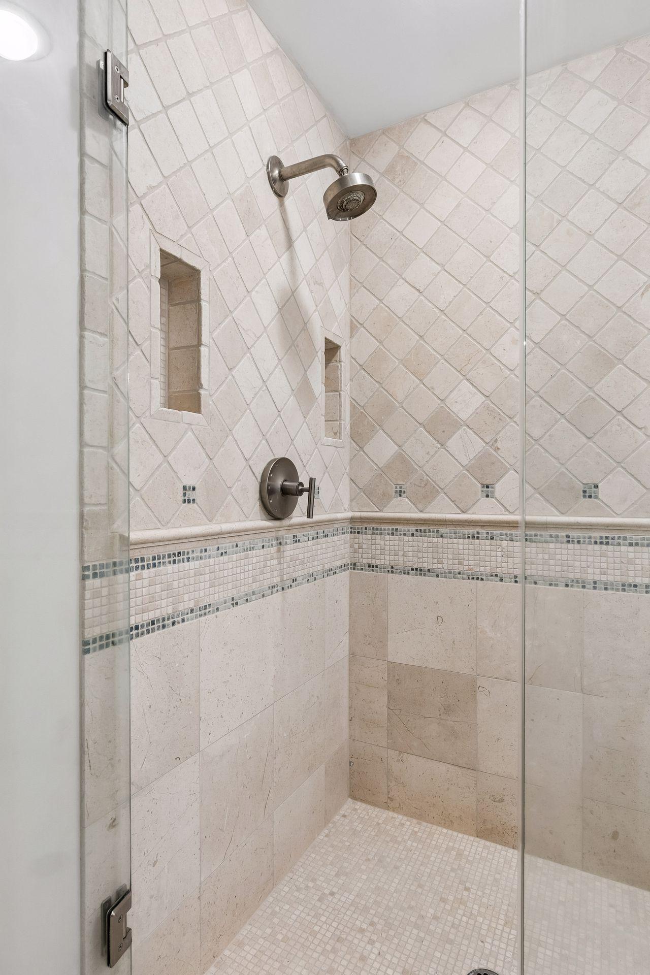 This primary suite is exceptional, featuring a spacious bedroom, a cozy reading nook, and a warm, spa-like bath with a separate tub and shower. Step out onto the private maintenance-free balcony and take in sweeping views of the 1+ acre lot and Lake
