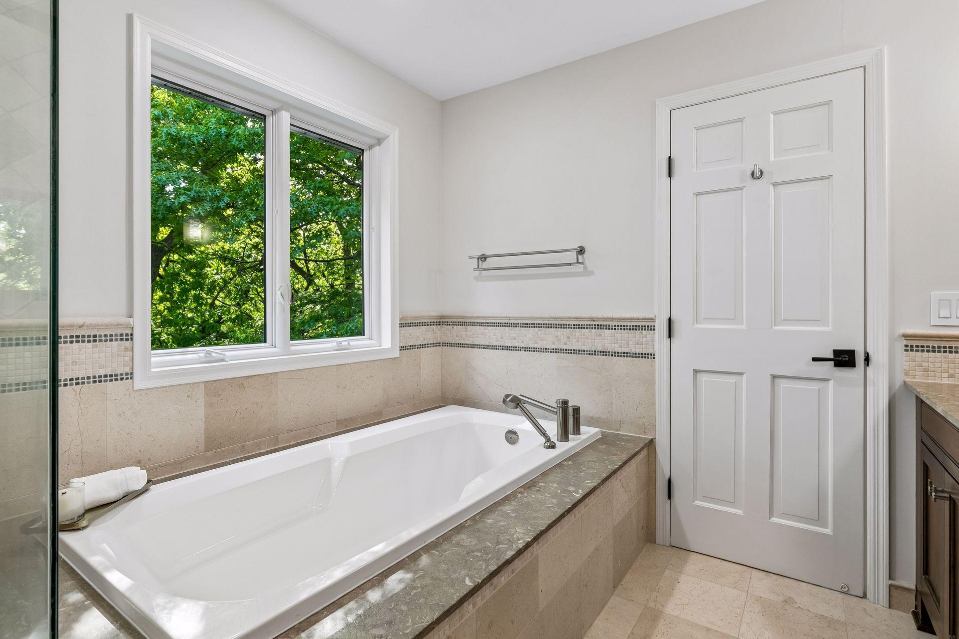 This primary suite is exceptional, featuring a spacious bedroom, a cozy reading nook, and a warm, spa-like bath with a separate tub and shower. Step out onto the private maintenance-free balcony and take in sweeping views of the 1+ acre lot and Lake