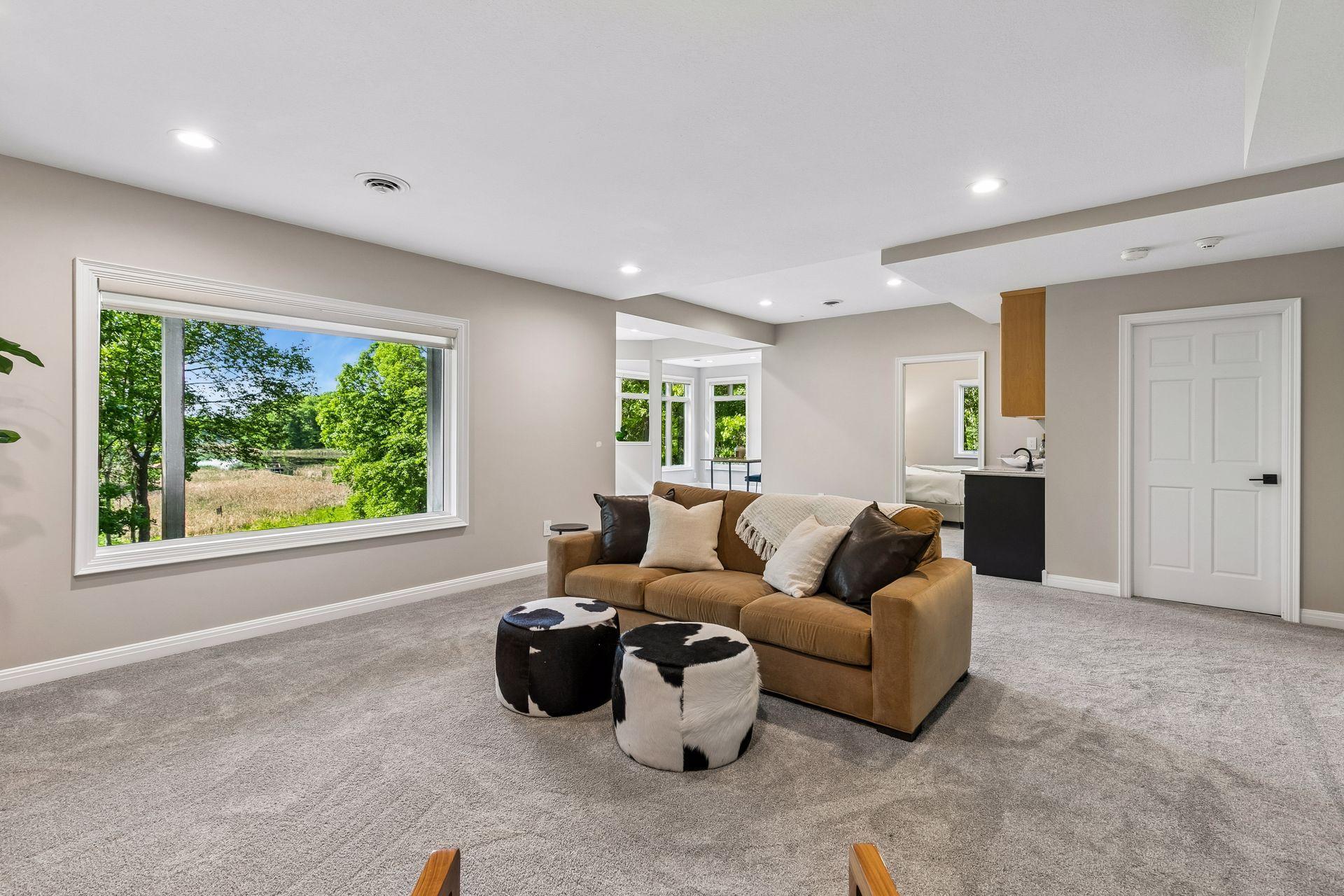 More views, more space, and more possibilities. The walkout lower level features a cozy family room with a gas fireplace and wet bar, a guest bedroom, bathroom, gym, and flexible play space that could easily be converted into an additional bedroom if
