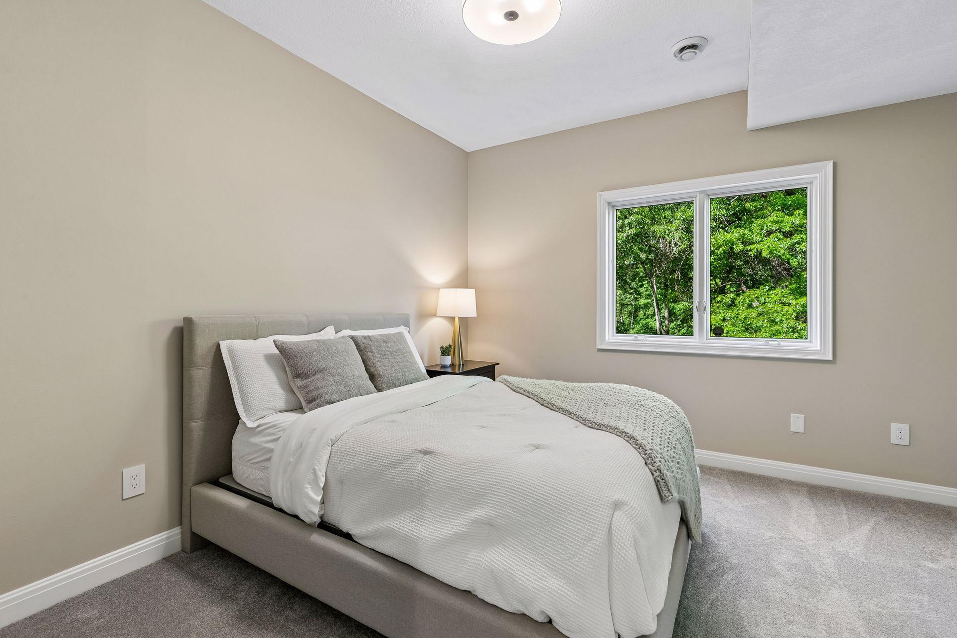 More views, more space, and more possibilities. The walkout lower level features a cozy family room with a gas fireplace and wet bar, a guest bedroom, bathroom, gym, and flexible play space that could easily be converted into an additional bedroom if