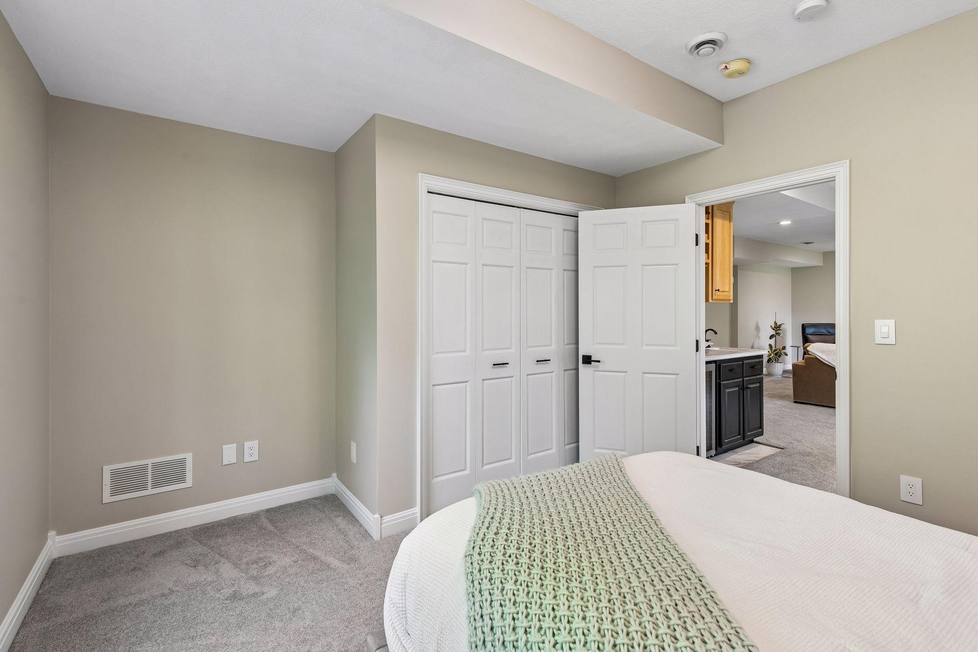 More views, more space, and more possibilities. The walkout lower level features a cozy family room with a gas fireplace and wet bar, a guest bedroom, bathroom, gym, and flexible play space that could easily be converted into an additional bedroom if