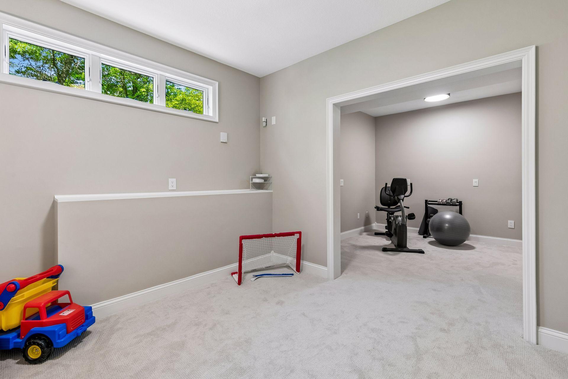More views, more space, and more possibilities. The walkout lower level features a cozy family room with a gas fireplace and wet bar, a guest bedroom, bathroom, gym, and flexible play space that could easily be converted into an additional bedroom if