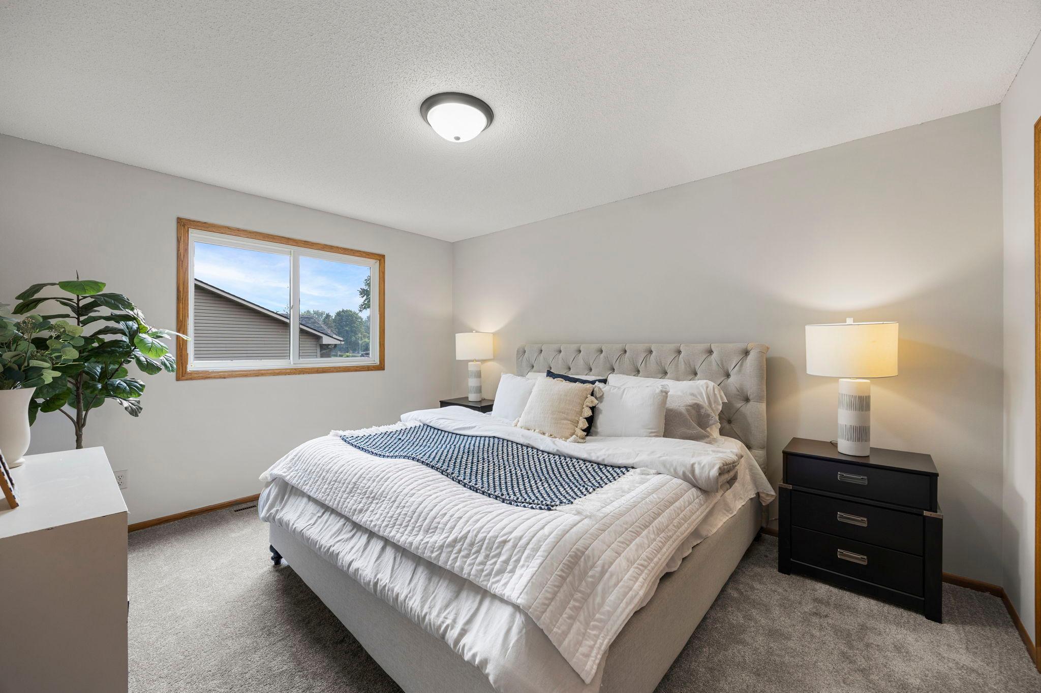 The upper level includes three bedrooms, including a spacious primary bedroom with carpeting and ample closet space.