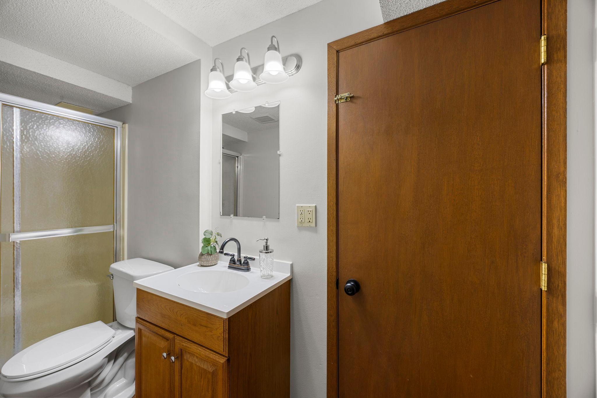 ust steps away is the lower-level 3/4 bathroom, featuring a single vanity and walk-in shower.