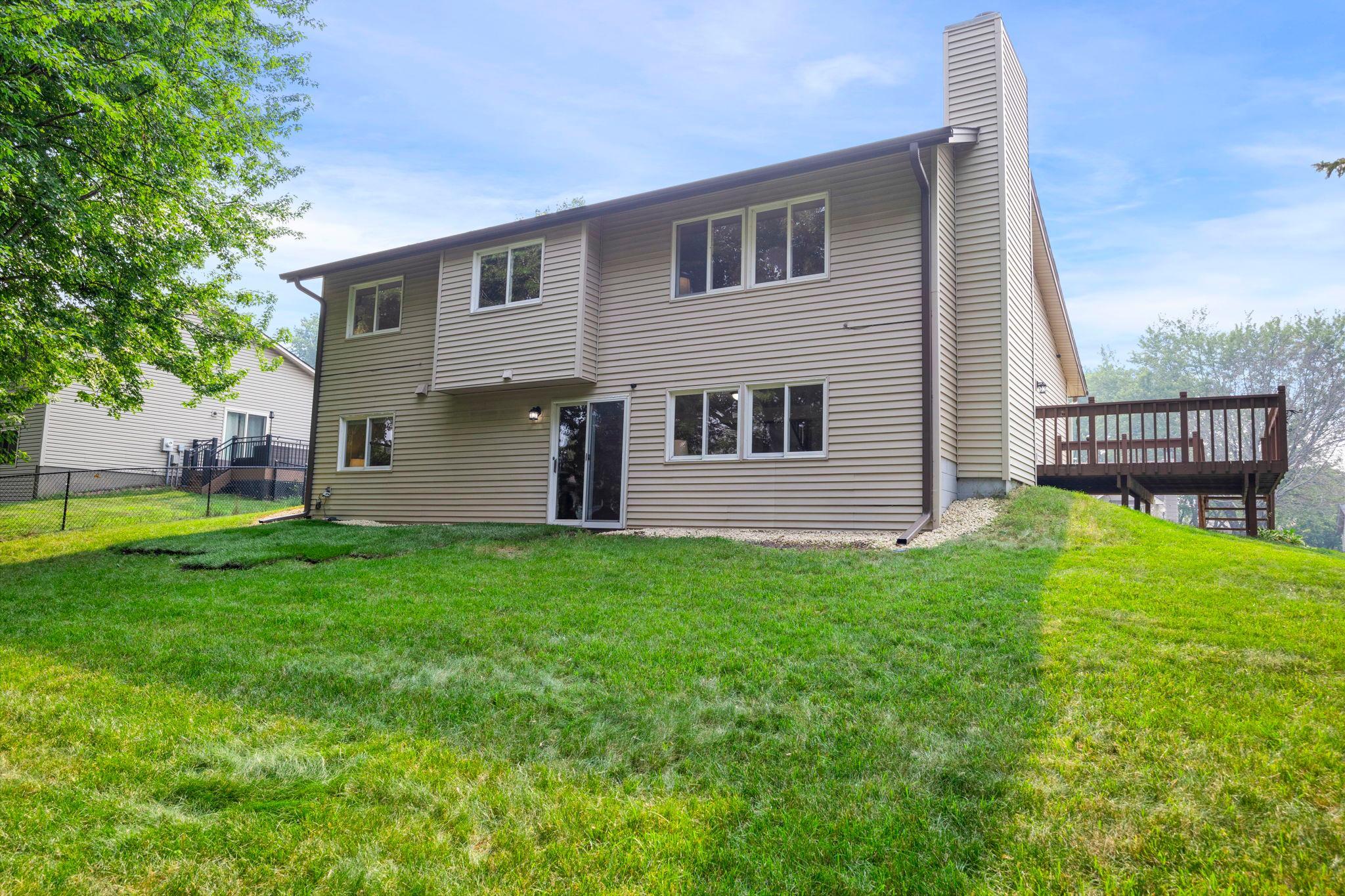 A look at the rear exterior of the home and its spacious backyard.