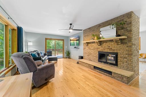 Two Sided Wooden Fireplace and Sliding Doors Leading to the Deck