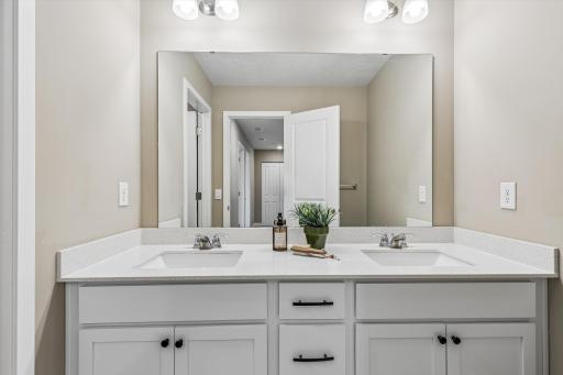 Dual Vanity with white cabinets in the Main Bath.