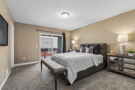 Primary Bedroom with Patio Doors leading to the Deck.