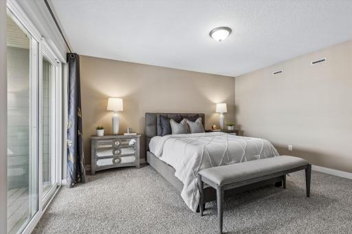Primary Bedroom with Patio Doors leading to the Deck.