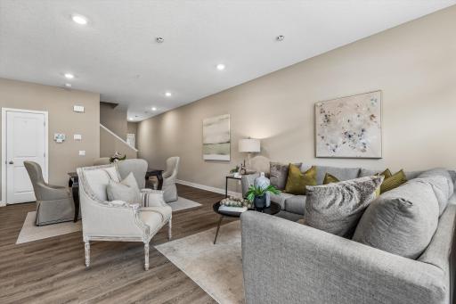 Very inviting and comfortable townhome with neutral color palette, wood grain appearance flooring. open-flow design and recessed lighting.