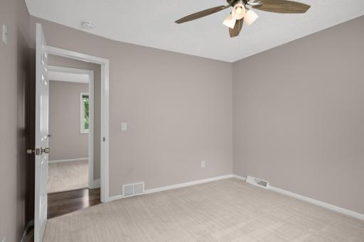 Main level owner's suite! Neutral paint, ceiling fan and private 3/4 bath with walk-in closet.