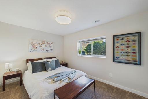 Lower-level bedroom, the 5th bedroom in the home overlooks the backyard.