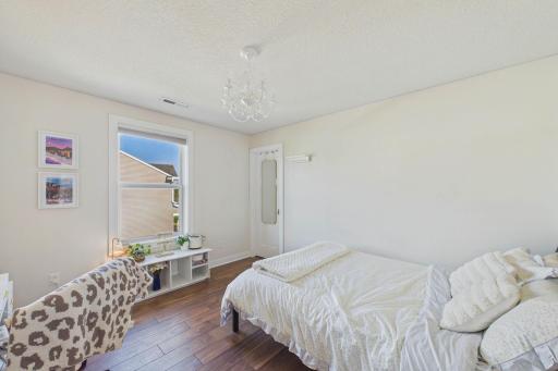 One of the four bedrooms on this level. Ahead and to the right is a walk-in closet! Note the modern flooring updated throughout.