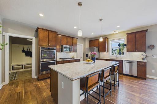 This gourmet kitchen features quartz countertops, premium Whirlpool stainless steel appliances, a double-oven with separate cooktop, built-in microwave, Bosch dishwasher and generous island!