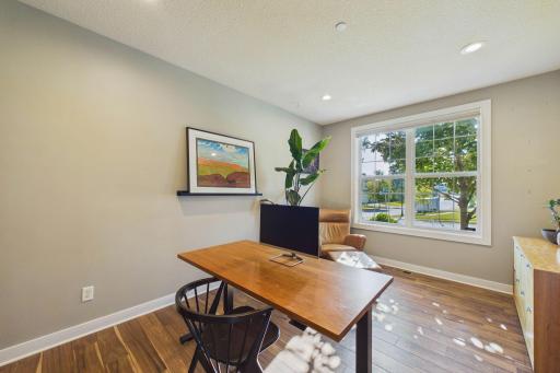 The office beams with natural sunlight from the large windows facing the front of the home! The recessed lighting and modern luxury vinyl plank flooring provides a clean feel to the space.