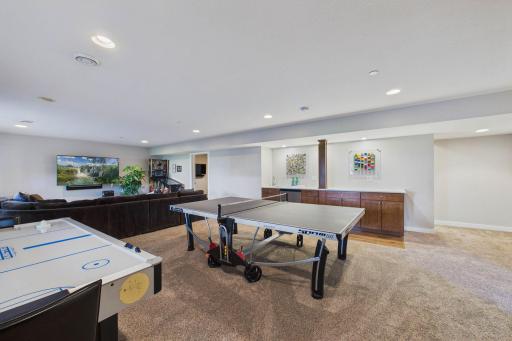 Ping-pong, air hockey anyone? The space is perfect for playing your favorite game! Additionally, the quartz countertop and bar sink add a great enhancement to the lower-level.