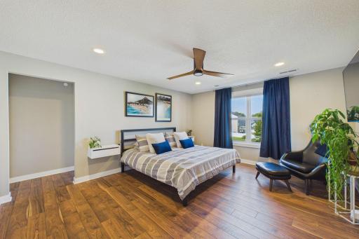 The primary bedroom suite offers terrific space. The bathroom and closet area are to the left and ahead.