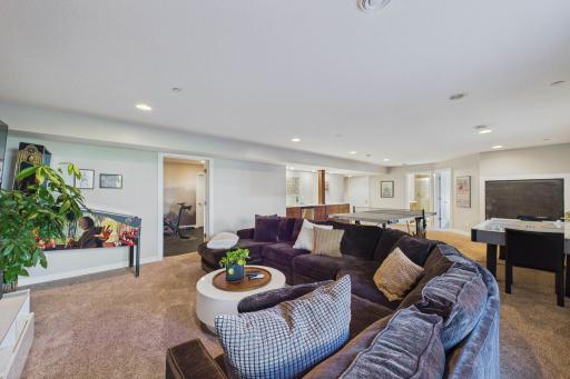 Movie night or game night? Either way, come have fun and hang out with friends in this large family room! The exercise room and storage are straight ahead.