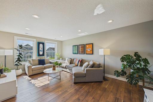 The beautiful luxury vinyl plank flooring add a modern touch to the loft area. This is an ideal space for a media or play area!