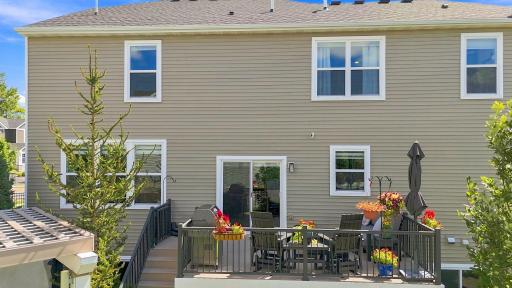 A view of the maintenance free deck and steps down to the yard. Enjoy warm summer evenings grilling with friends.