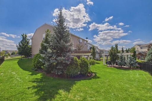 The fully fenced private yard offers your own private oasis with two separate patios with pergolas, ideal for outdoor dining, lounging, and year-round enjoyment!