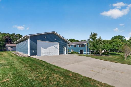 Oversized detached garage with a wide concrete driveway and convenient access to the home.