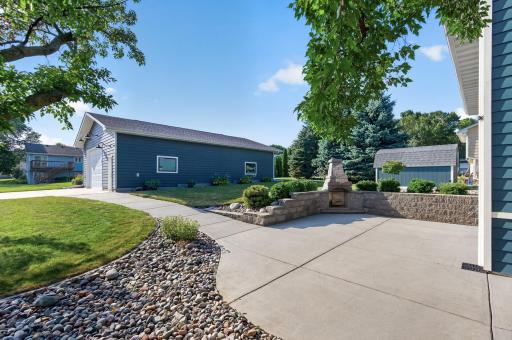 Large concrete patio with built-in outdoor fireplace creates a fantastic space for outdoor entertaining.