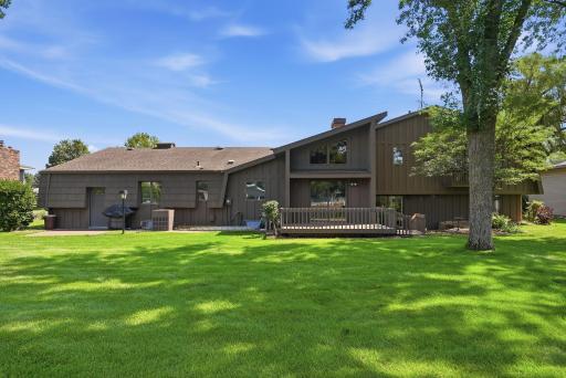 Lush plantings and established grounds give the property a warm, inviting presence.