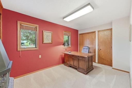 Currently functioning as an office, this bedroom offers plenty of space for a desk and furnishings.