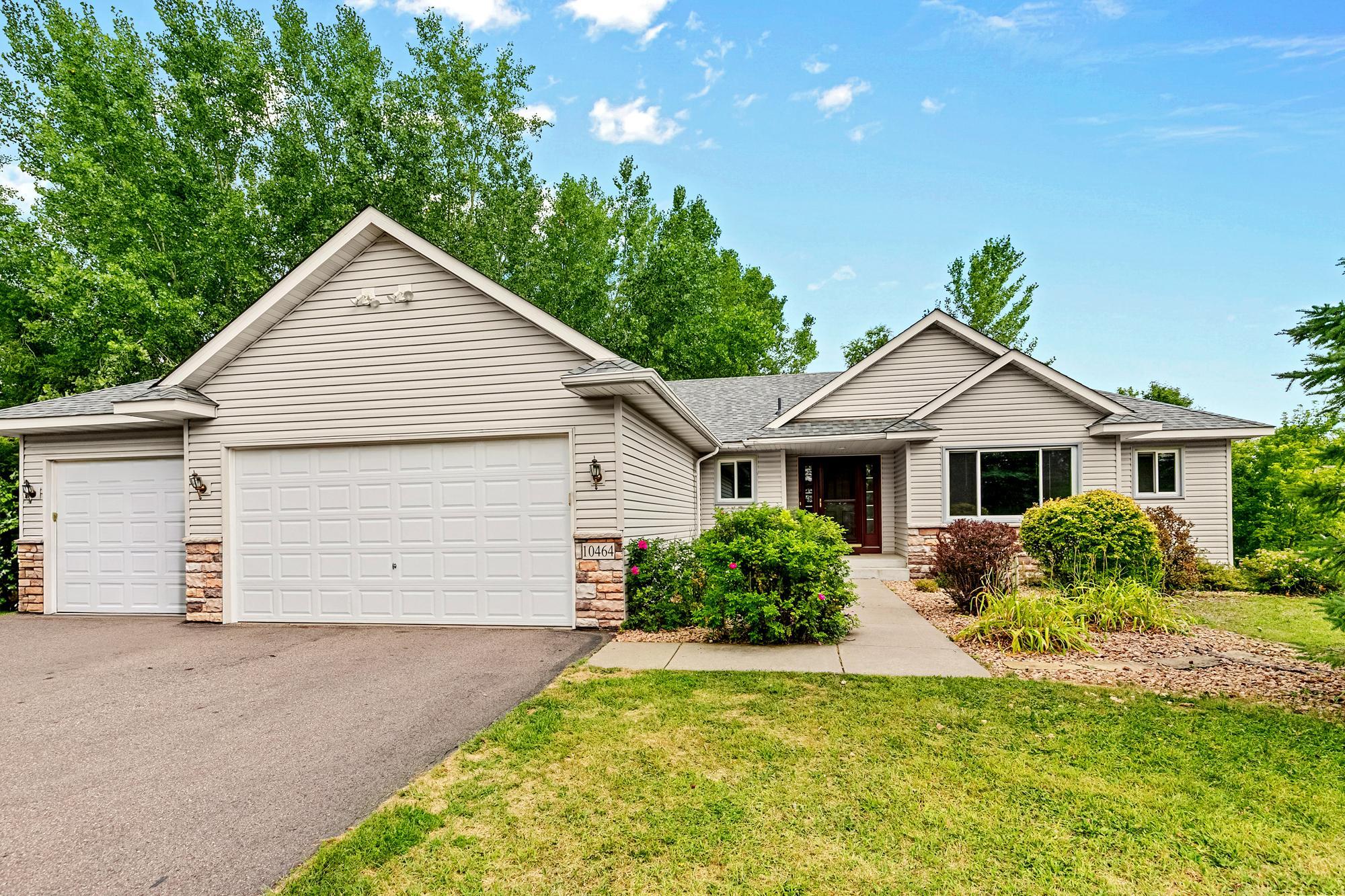 Lush mature trees and a beautifully landscaped front walkway invite you right up to the front door.