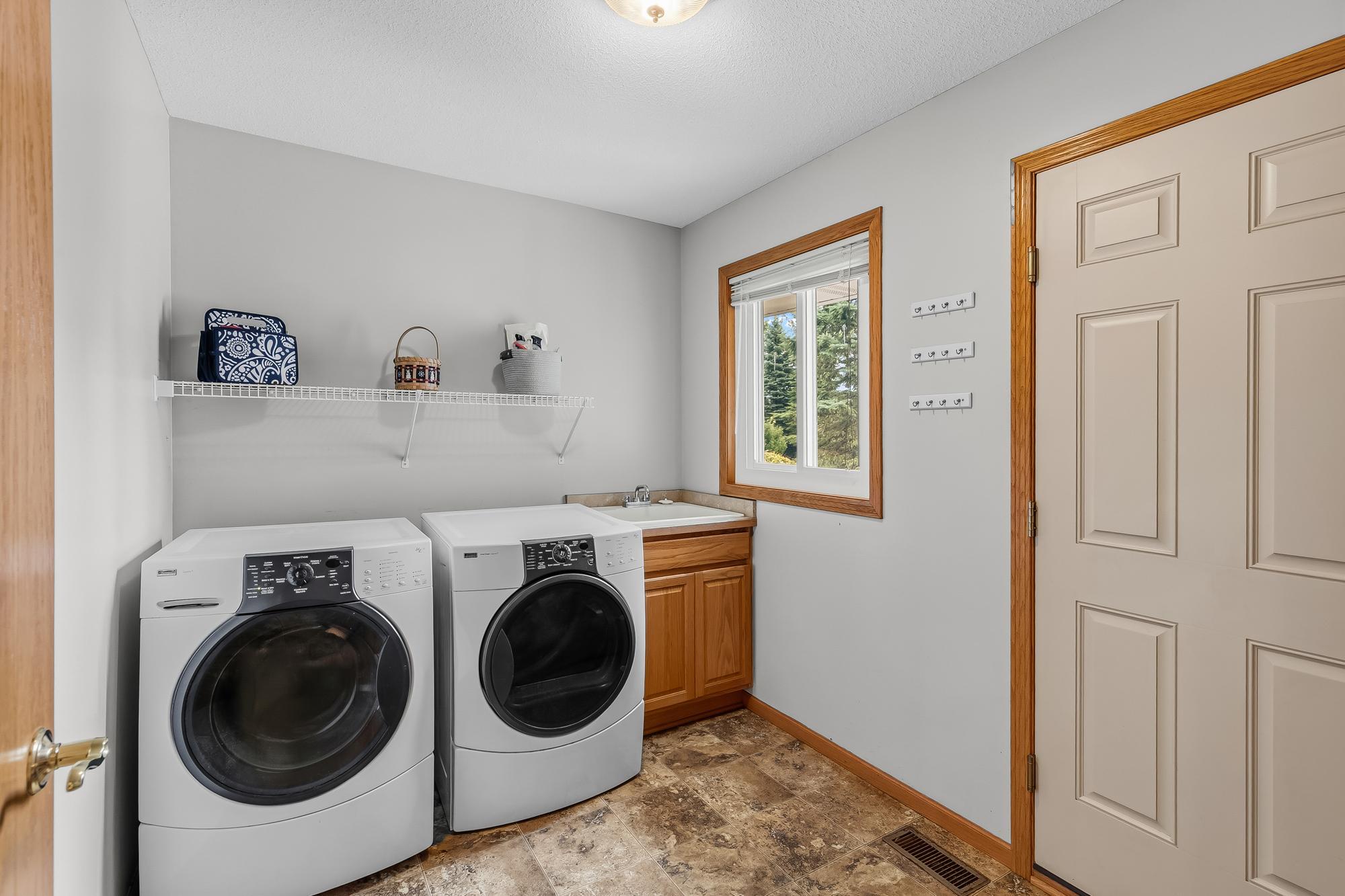 Enjoy the ultimate convenience of a dedicated main-floor laundry room equipped with a utility sink.