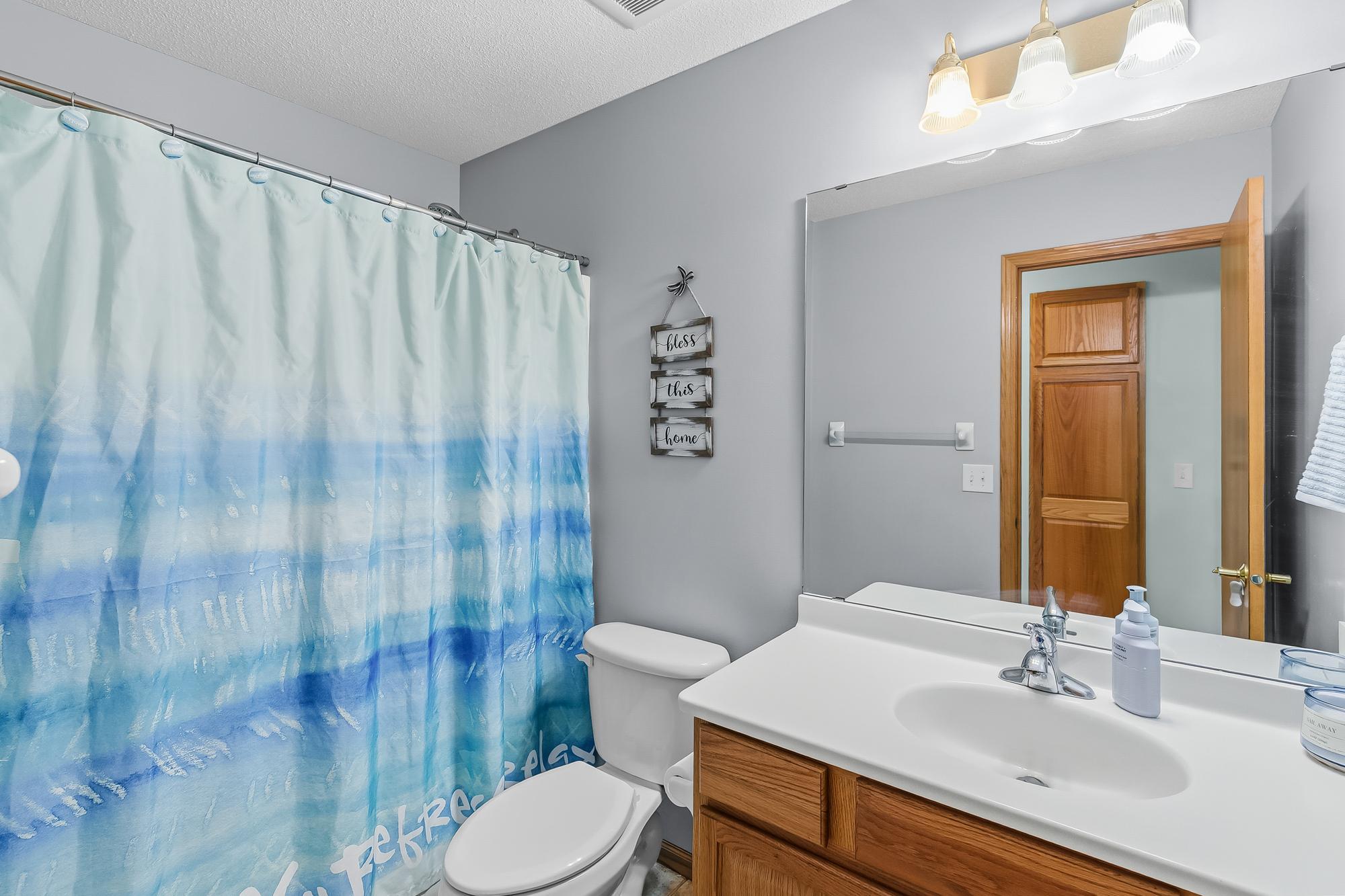 One of three bathrooms in the home, this full bath is bright, clean, and perfectly situated for family and guests.