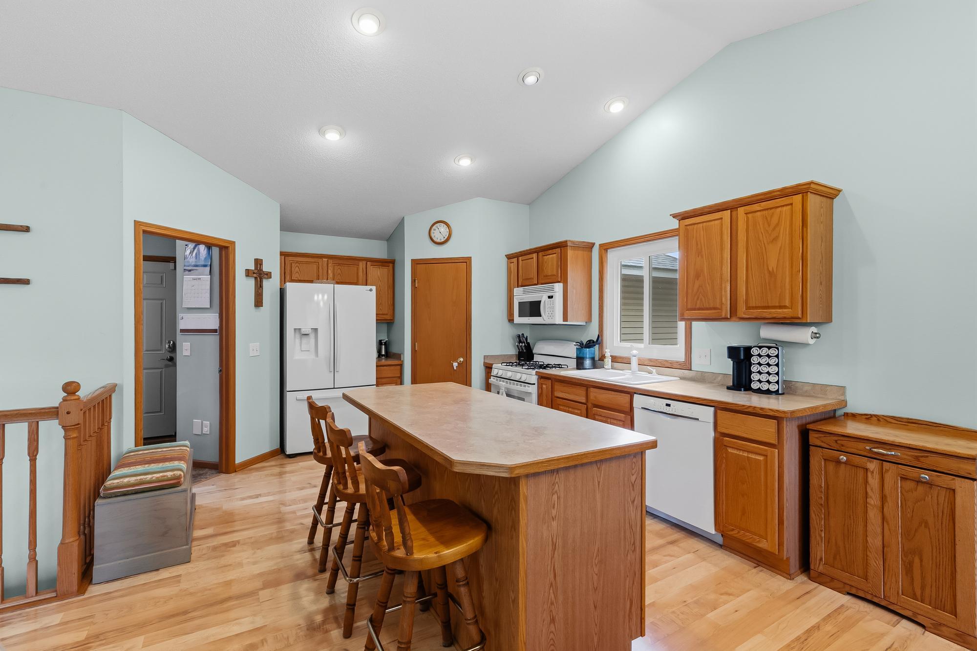 The kitchen features a convenient center island and ample cabinetry for all your culinary needs.