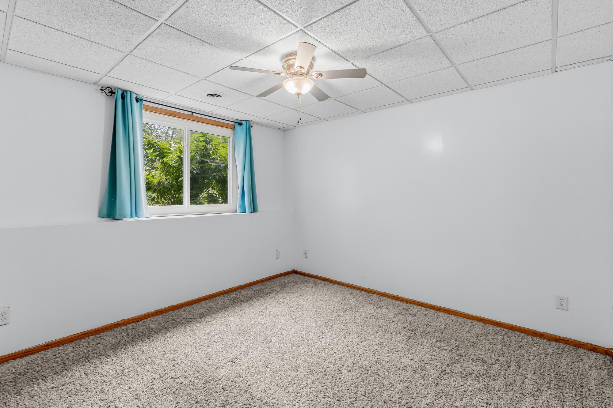 Another spacious lower-level bedroom provides a quiet, private retreat for family or guests.