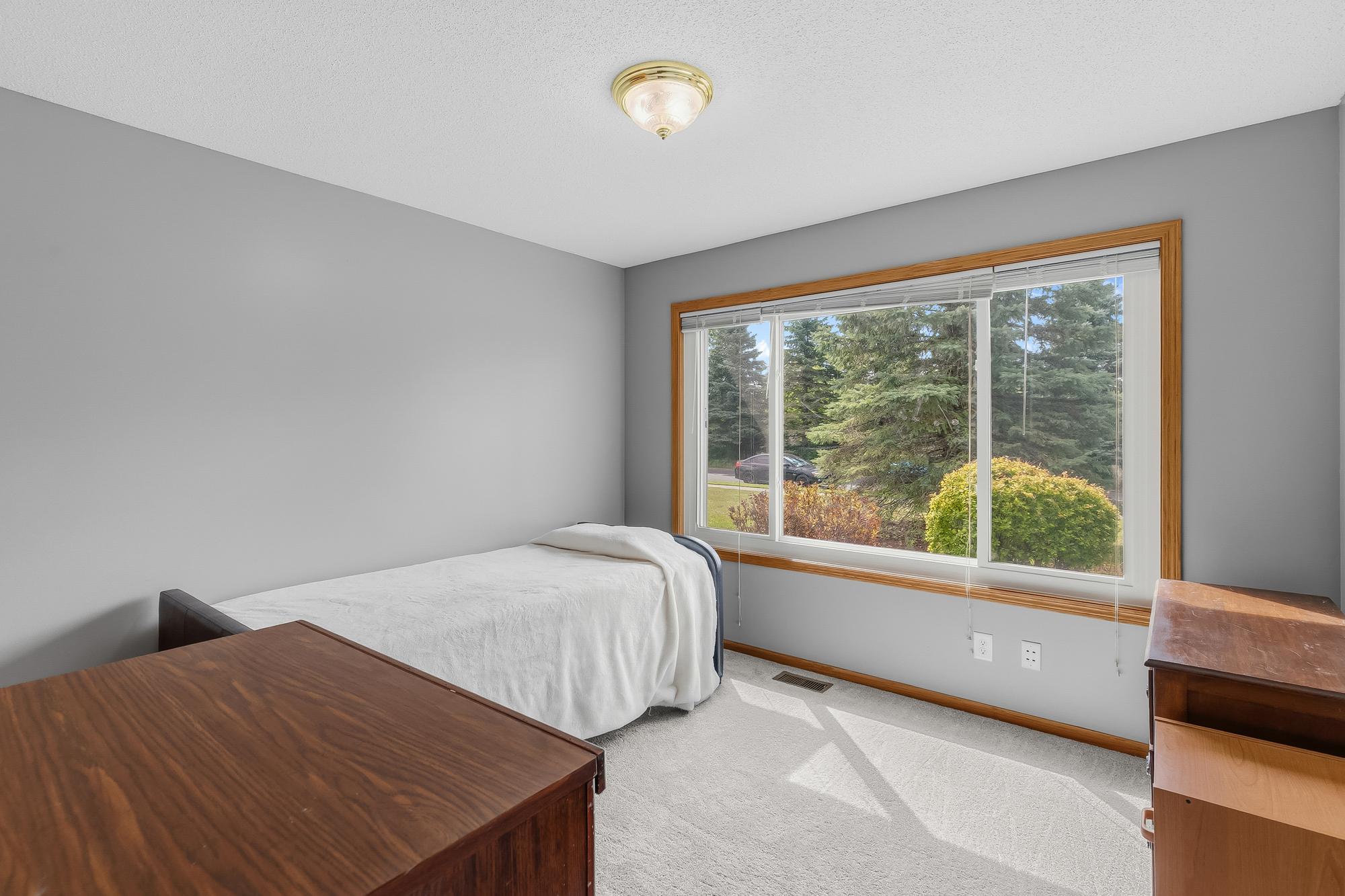 This bright and comfortable space is one of the four generously sized bedrooms found in the home.