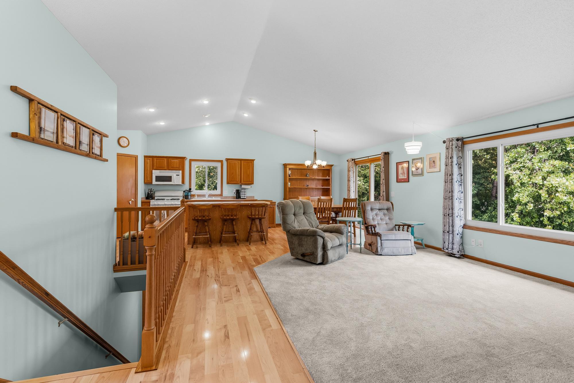 The open floor plan is perfect for entertaining, highlighted by soaring vaulted ceilings.
